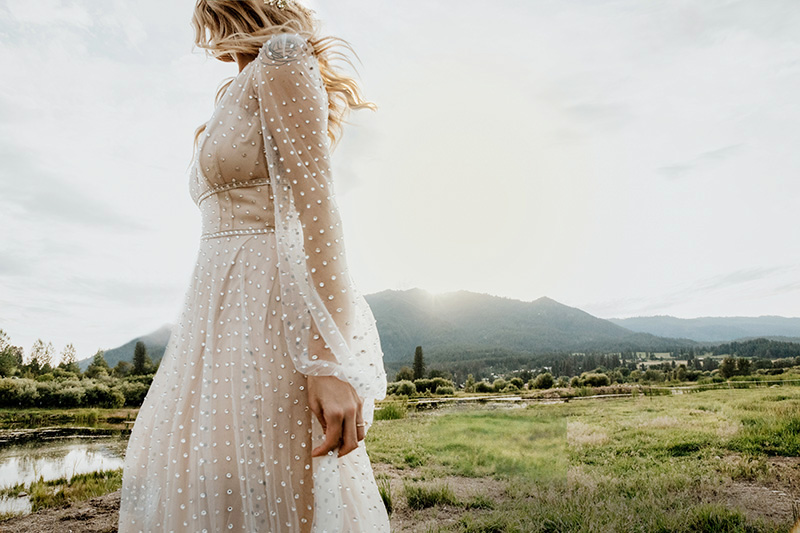 A bride turns into the last of the evening sun, the Sawtooth foothills falling away behind her.